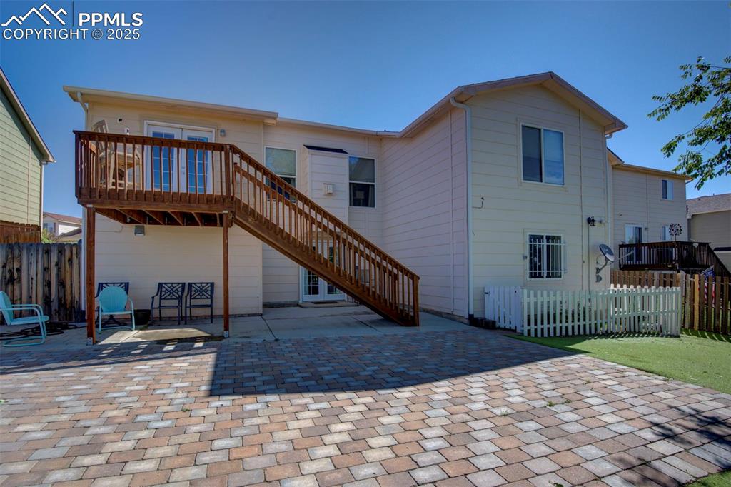 Image 38 of 44: Rear view of house with a patio area and stairs