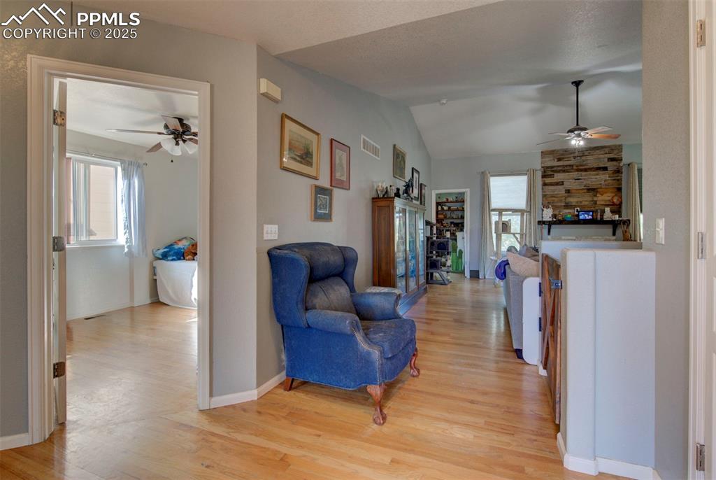 Image 4 of 44: Living room featuring ceiling fan, light wood-type flooring, healthy amount