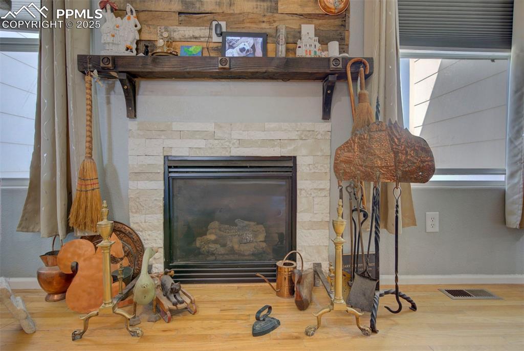 Image 8 of 44: Detailed view of wood finished floors and a stone fireplace