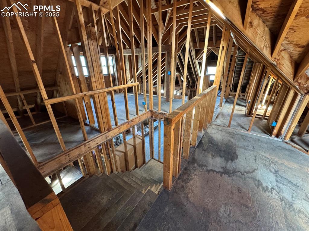 Image 19 of 19: Unfinished attic featuring an upstairs landing