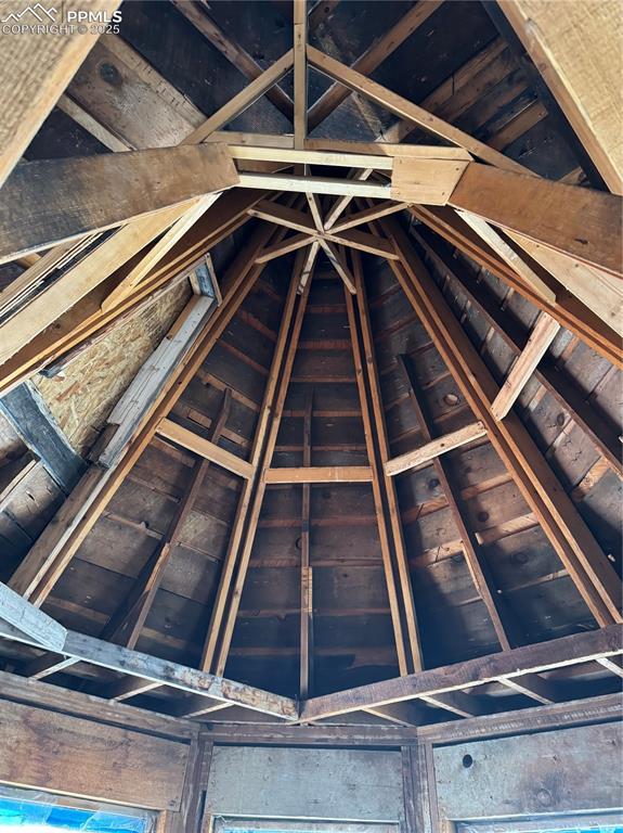 Image 5 of 19: Unfinished attic with wine cooler