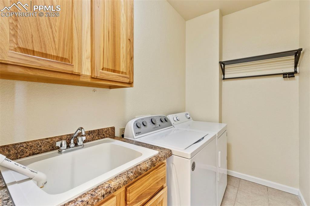 Image 22 of 26: Washer and Dryer included and comes with Utility Sink and Cabinets