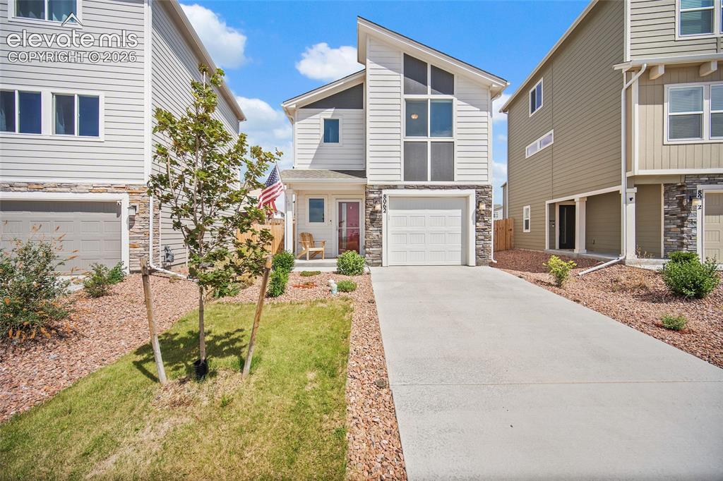 Caption: Modern facade with mixed siding and stone accents