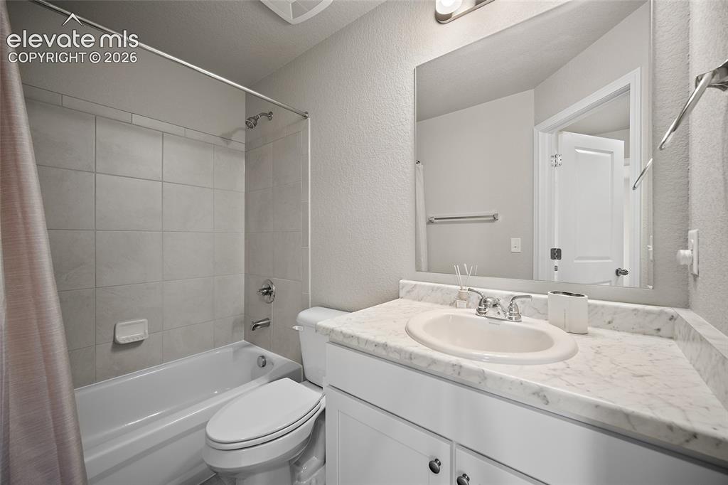 Image 23 of 40: Bathroom featuring a single vanity with a white countertop and undermount s