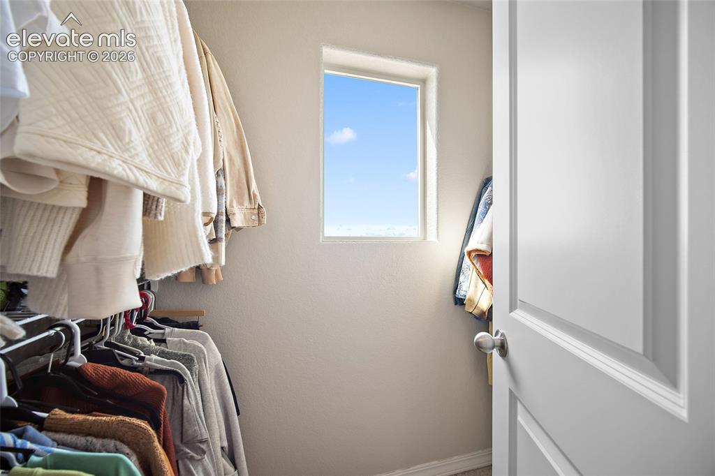 Image 24 of 40: Interior closet featuring a single window, white trim, and a paneled white