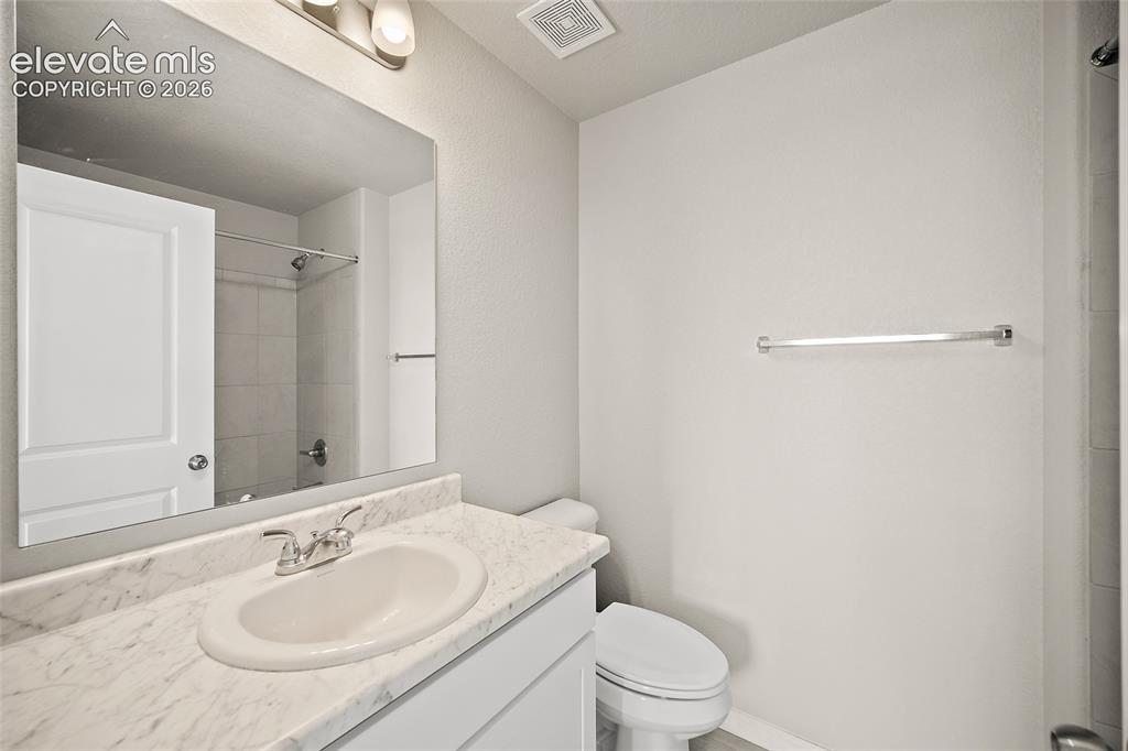 Image 27 of 40: Bathroom featuring a vanity with a white countertop, an undermount sink, an