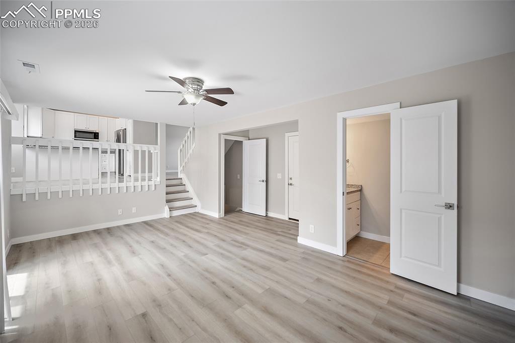 Image 14 of 36: Open-concept living area featuring wood-finish flooring, a contemporary cei