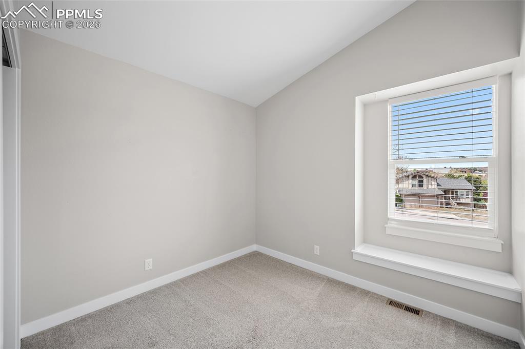Image 19 of 36: Vaulted ceiling with light-toned wall finishes