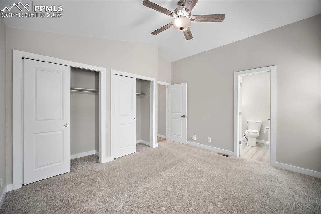 Image 25 of 36: Carpeted room featuring a ceiling fan with light fixture, vaulted ceiling, 