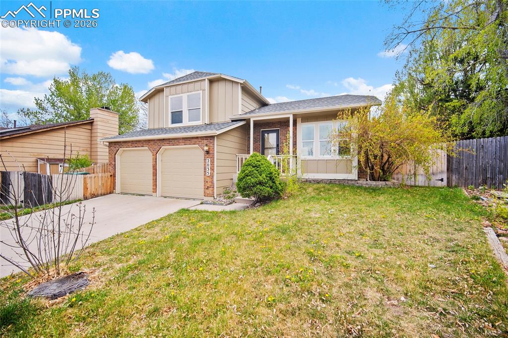 Image 3 of 36: Exterior with a two-car garage, concrete driveway, and front lawn
