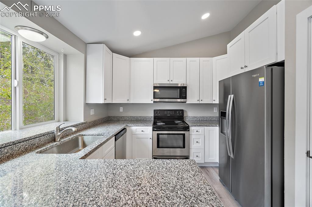 Image 9 of 36: Kitchen featuring granite-style countertops, stainless steel appliances, wh