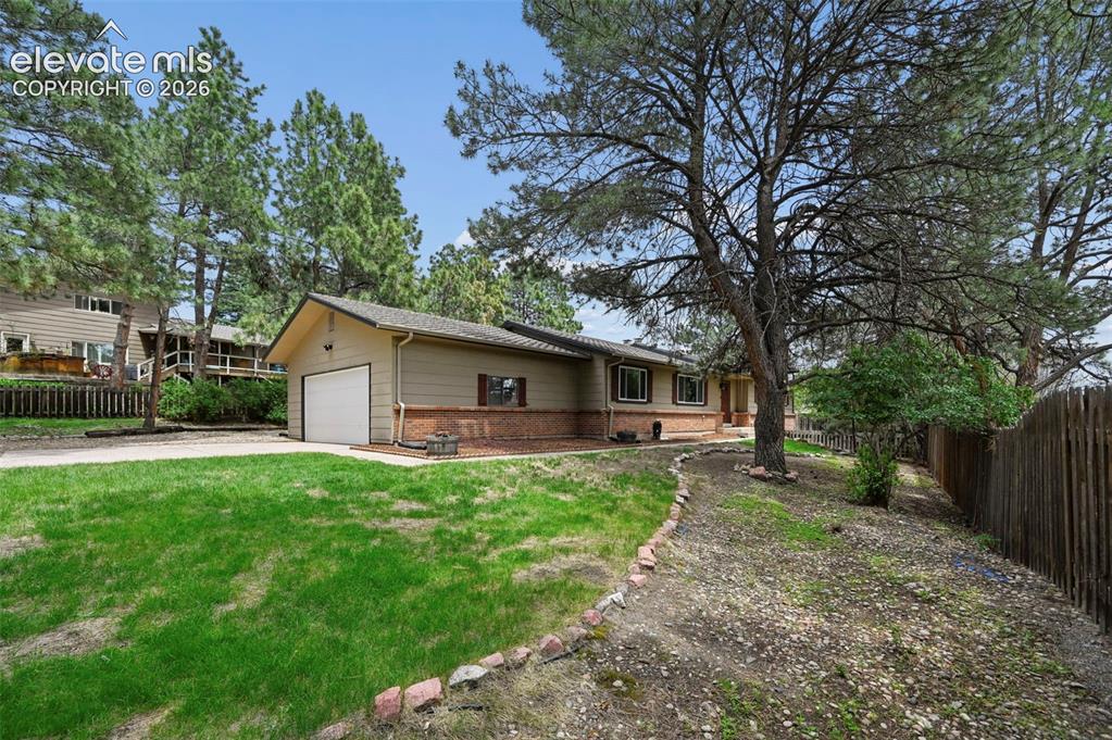 Image 3 of 33: Front of home on spacious flag lot
