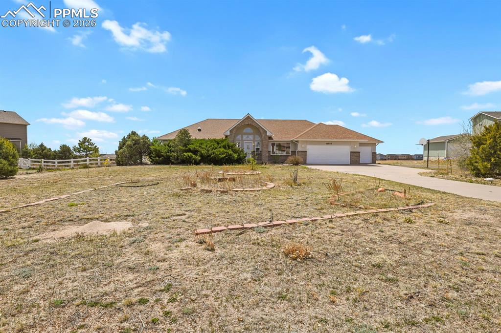Image 1 of 37: Ranch-style house featuring a garage and driveway