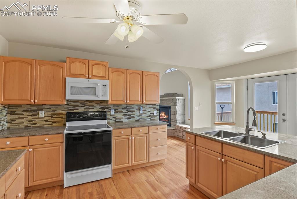 Image 10 of 37: Kitchen with Wood Flooring, and stone counters