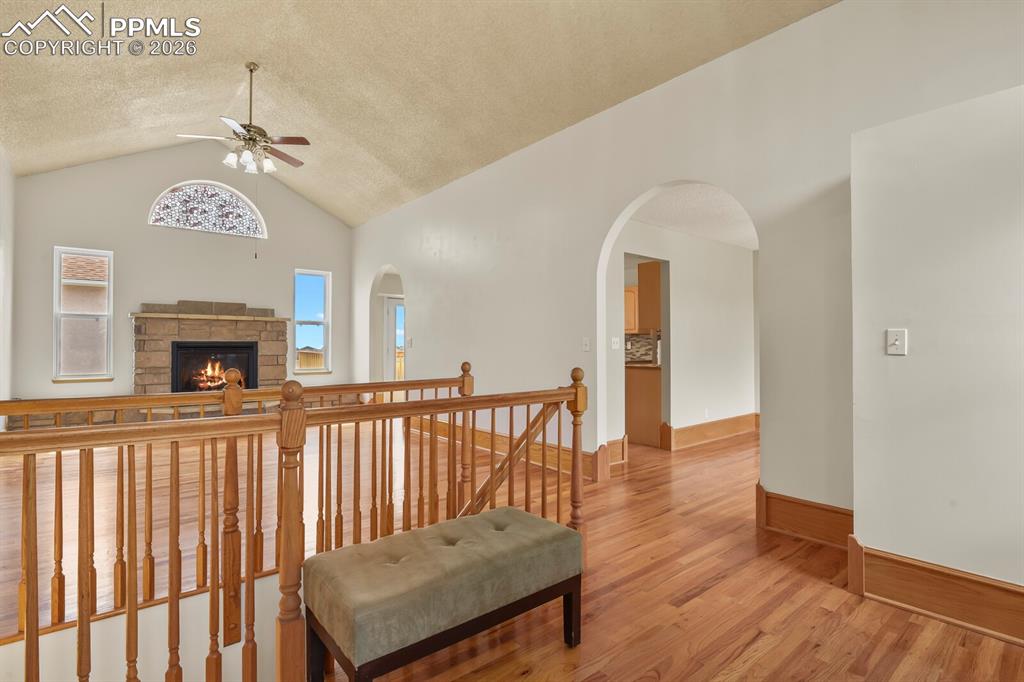 Image 2 of 37: Entry with wood finished floors, an upstairs landing, and arched walkways