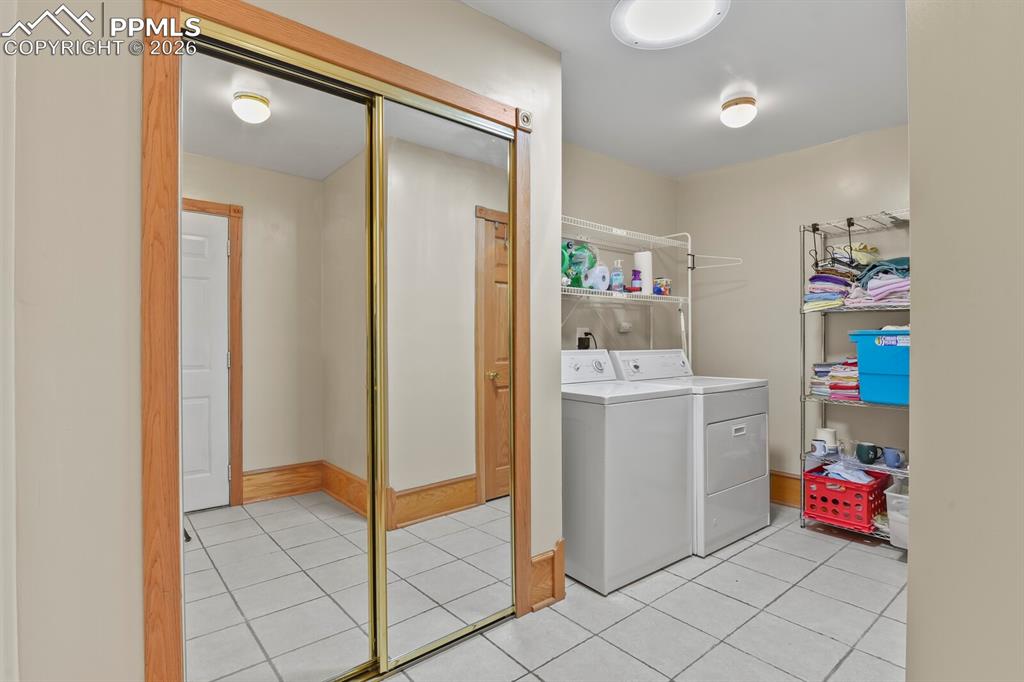 Image 21 of 37: Laundry room with Closet, Hanging Racks, and Tile Floor