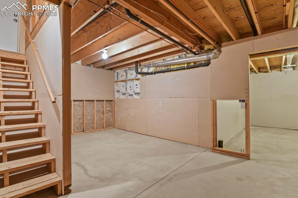 Image 23 of 37: Unfinished basement with stairs directly to the Garage