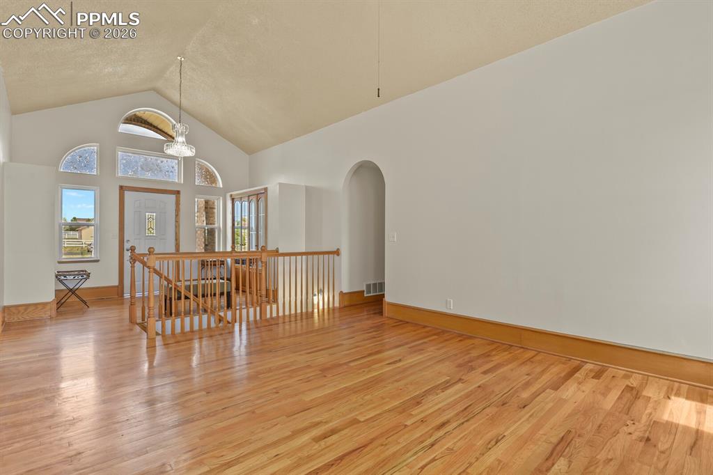 Image 6 of 37: Living Room Looking to Entry and Stairs to Basement