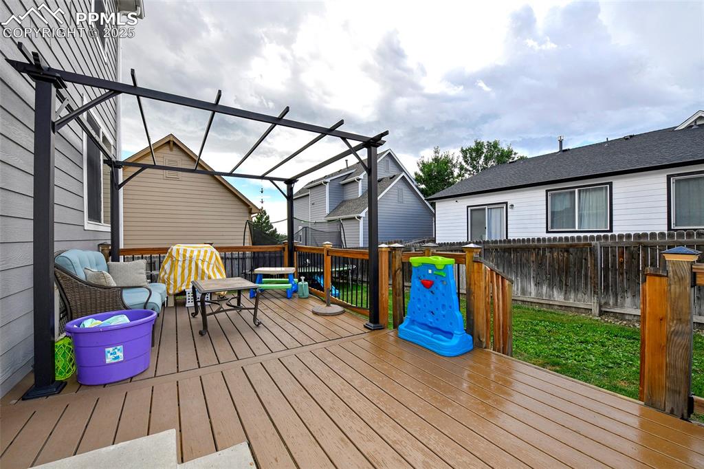 Image 12 of 28: Huge deck with pergola