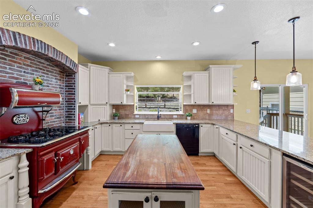 Image 9 of 50: Chef’s Kitchen with Brick Accents