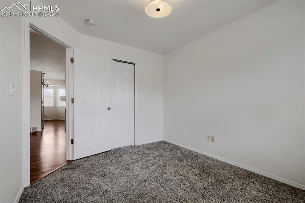 Image 10 of 32: Room featuring grey textured carpeting, white walls, a flush-mount ceiling 