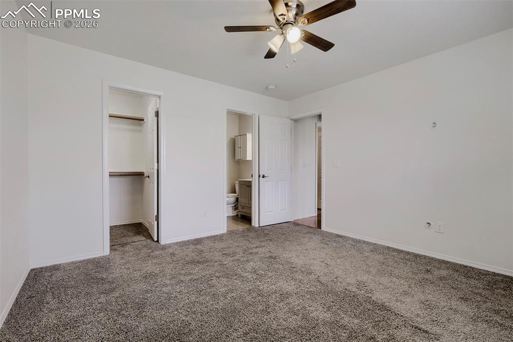 Image 19 of 32: Carpeted interior space featuring a ceiling fan with integrated lighting, a
