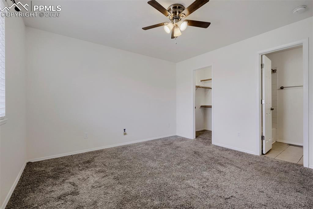Image 20 of 32: Carpeted room featuring a sloped ceiling, ceiling fan with integrated light