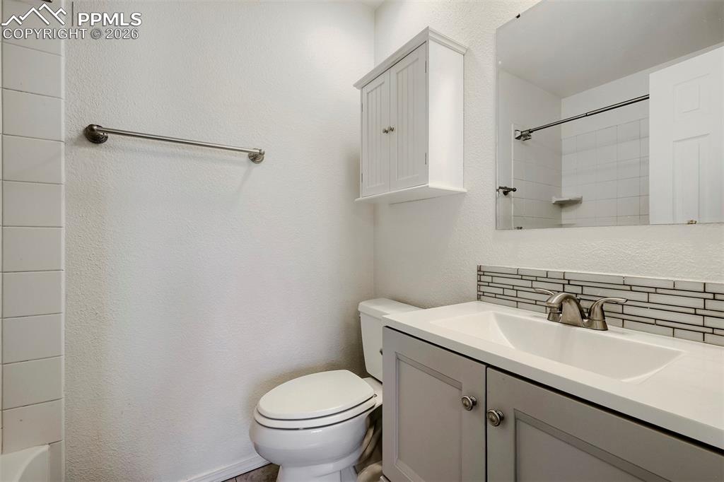 Image 26 of 32: Bathroom with a single vanity, undermount sink, and a two-handle faucet