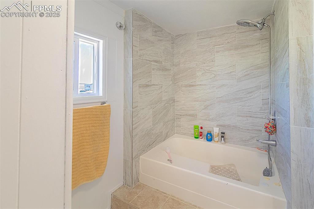 Image 13 of 38: Full bathroom featuring shower / tub combination