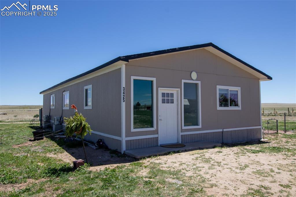 Image 15 of 38: 3425 Wiesner - View of front facade with cooling unit