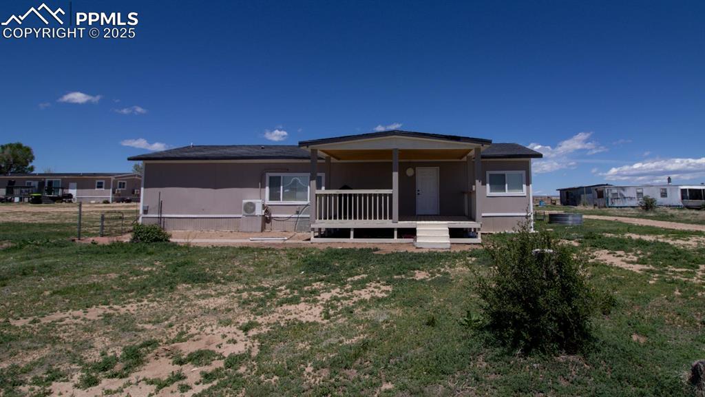 Image 16 of 38: 3425 Wiesner - Back of house with a lawn and a cooling unit