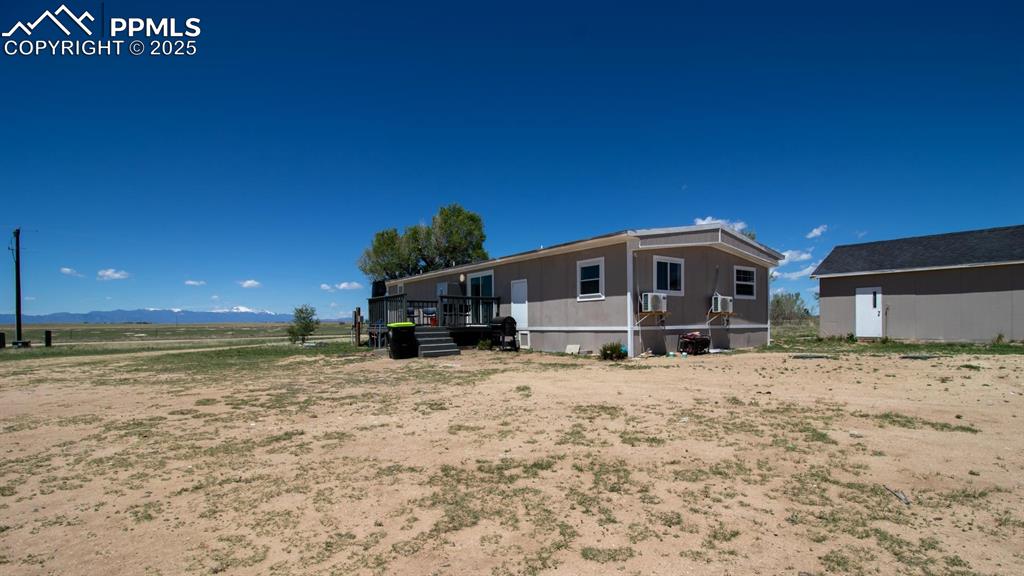 Image 26 of 38: 3415 Wiesner - Rear view of house with a deck