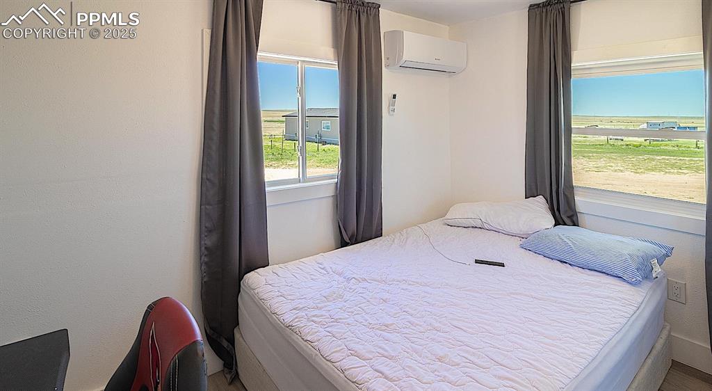 Image 38 of 38: Bedroom with a wall mounted AC