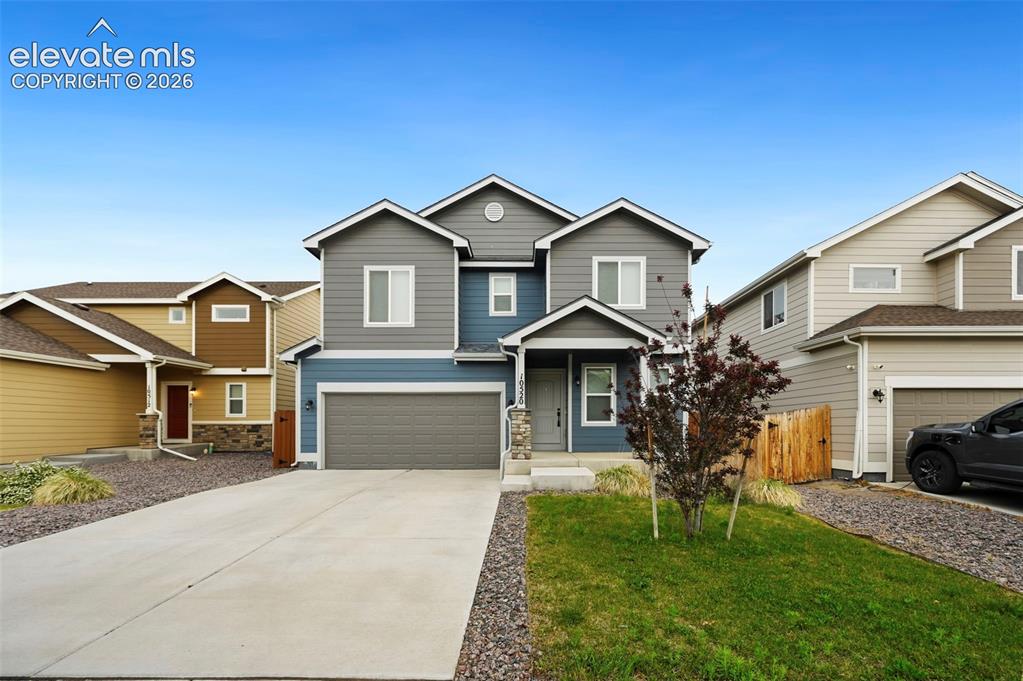 Image 26 of 28: Two-story residence featuring a multi-toned exterior with blue and gray sid