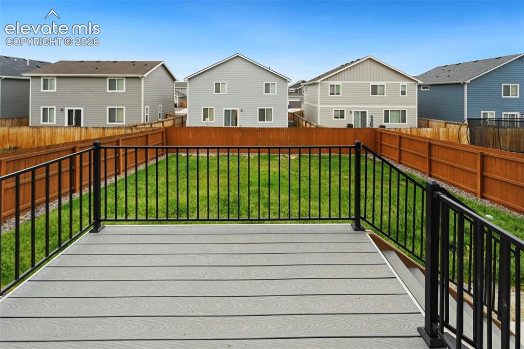 Image 27 of 28: Outdoor deck featuring composite decking in a light gray finish, black meta
