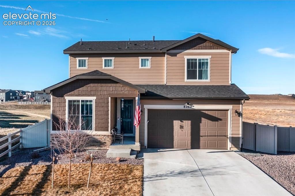 Image 1 of 34: Two-story residence featuring a two-car garage, front porch, and a combinat
