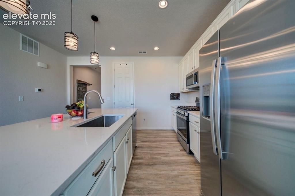 Image 11 of 34: Kitchen featuring a center island with an undermount sink and gooseneck fau