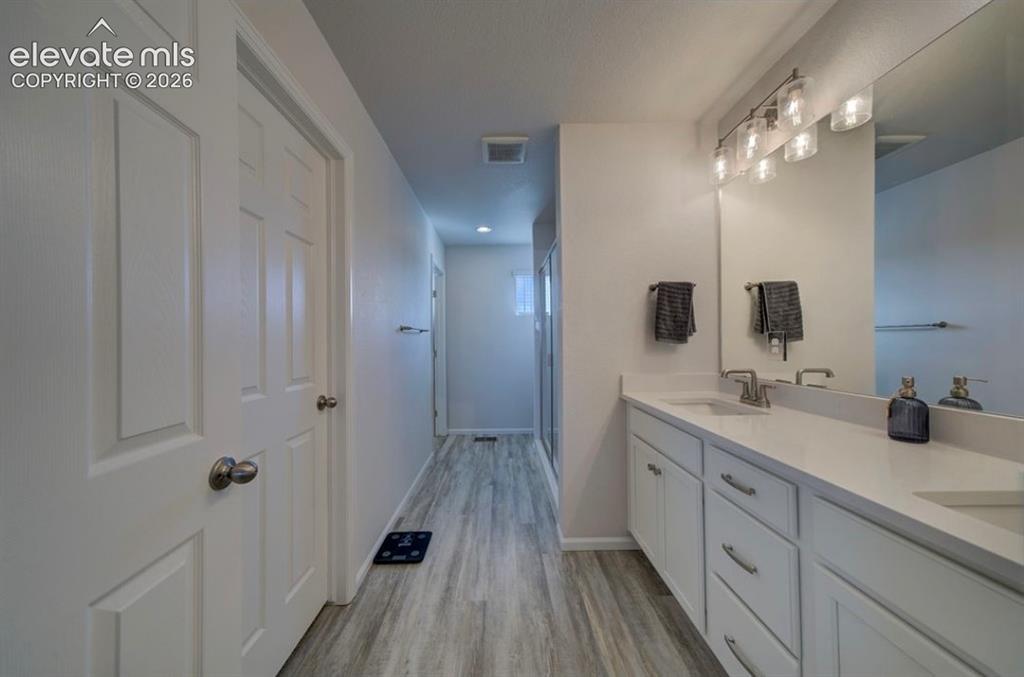 Image 20 of 34: Dual vanity with ample counter space, undermount sinks, and contemporary li