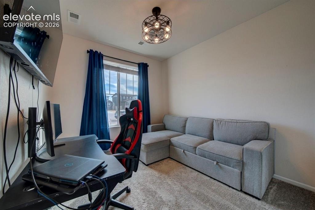 Image 28 of 34: Recessed lighting, wall-mounted television, window with full curtains, and 