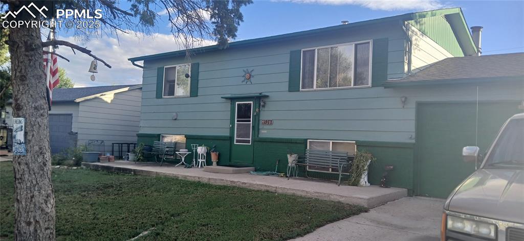Caption: Back of house featuring a lawn