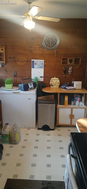 Image 10 of 33: Kitchen with light floors, refrigerator, and white cabinets