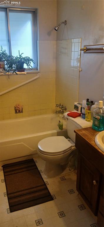Image 11 of 33: Full bathroom featuring vanity and shower / tub combination