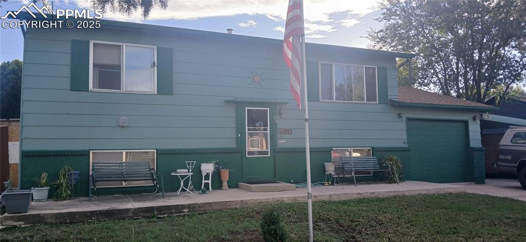 Image 2 of 33: Rear view of house featuring a garage