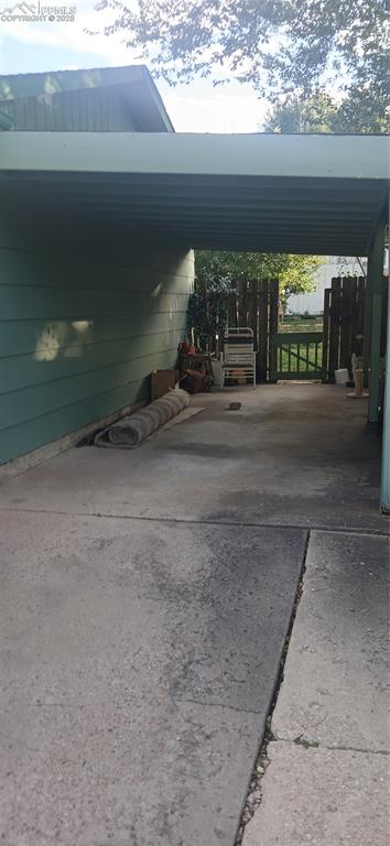 Image 3 of 33: View of parking / parking lot featuring a carport and driveway