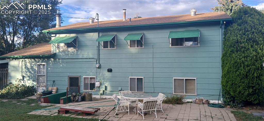 Image 32 of 33: Back of property with a patio and a shingled roof