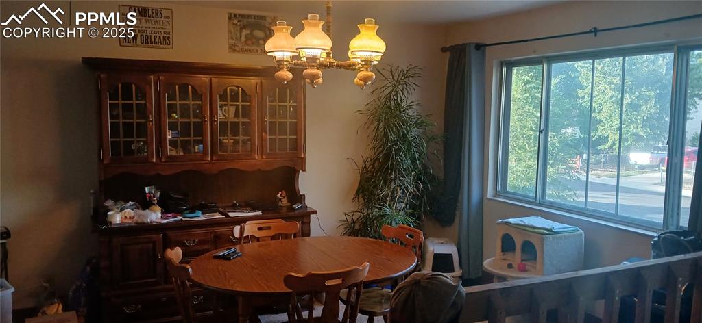 Image 4 of 33: Dining room featuring a chandelier