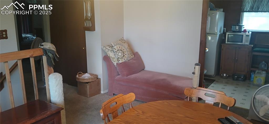 Image 7 of 33: Dining room with carpet floors