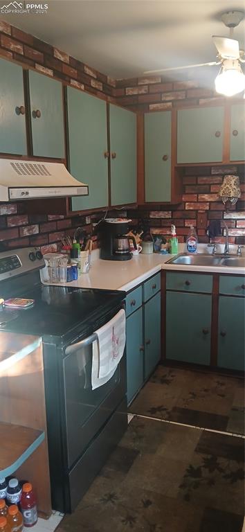 Image 9 of 33: Kitchen featuring stove, green cabinets, and Vent hood