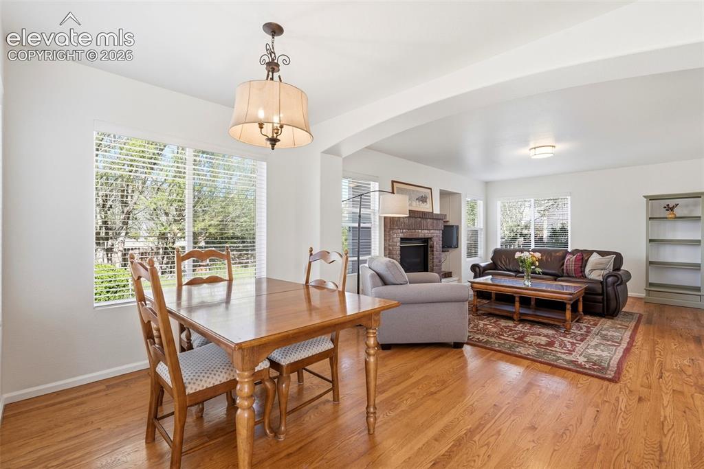 Image 16 of 37: Hardwood-style flooring throughout the open-concept living and dining areas