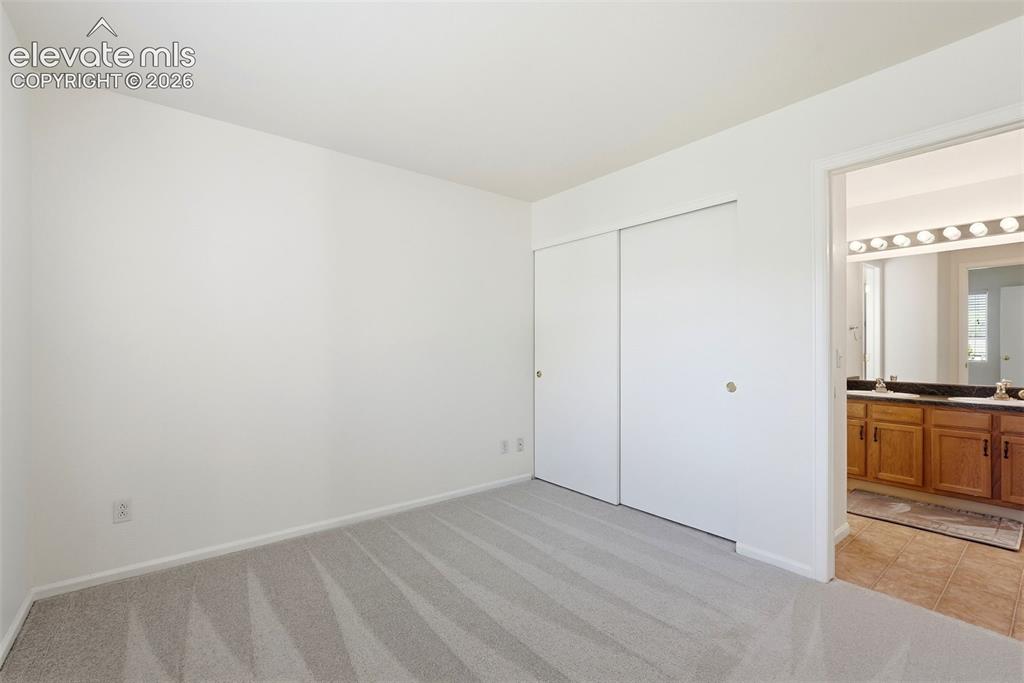 Image 19 of 37: Neutral wall colors with light gray carpeting